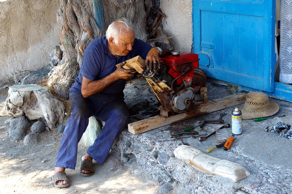 At the side of the road repairing an engine, and why not?  The people of Greece are very much about doing things themselves when they can.