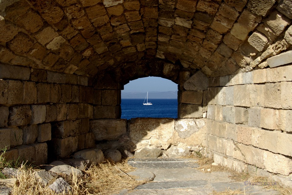 Walking the inner wall of Neratzia Castle in Kos town and peeking through an embrasure. There, at anchor, a boat perfectly framed.