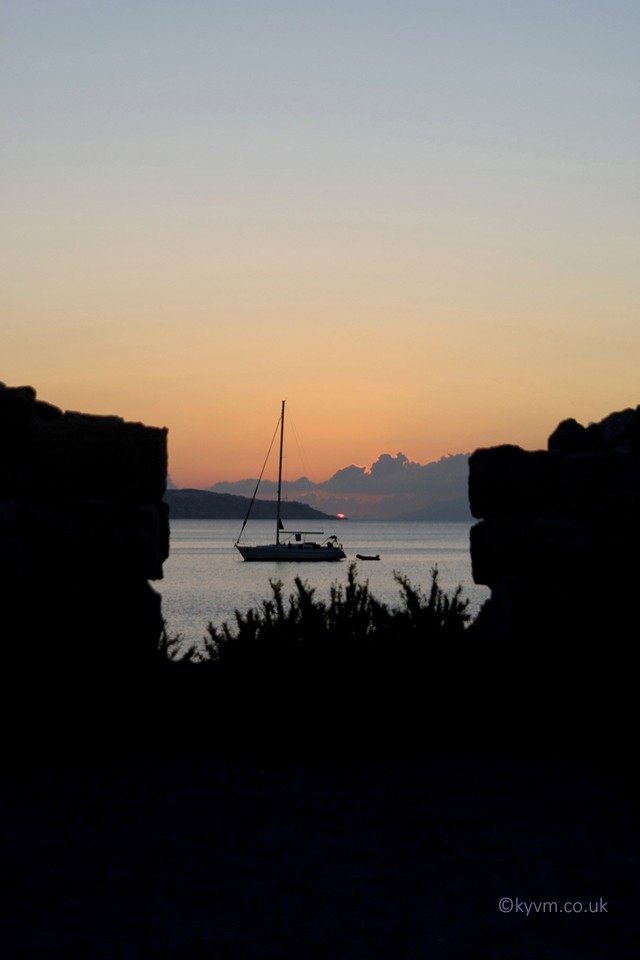 One of the few sunrise shots I have taken as rarely am I awake so early when in Greece.  The ruins of the Basilica St. Stefanos in Kefalos at the end of the long beach. I knew I wanted to be there for it. The boat was an unexpected bonus.